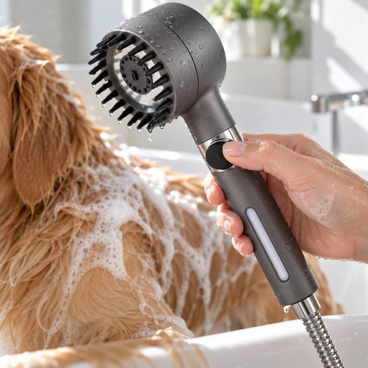 Hand pressing the pause button on the shower head handle